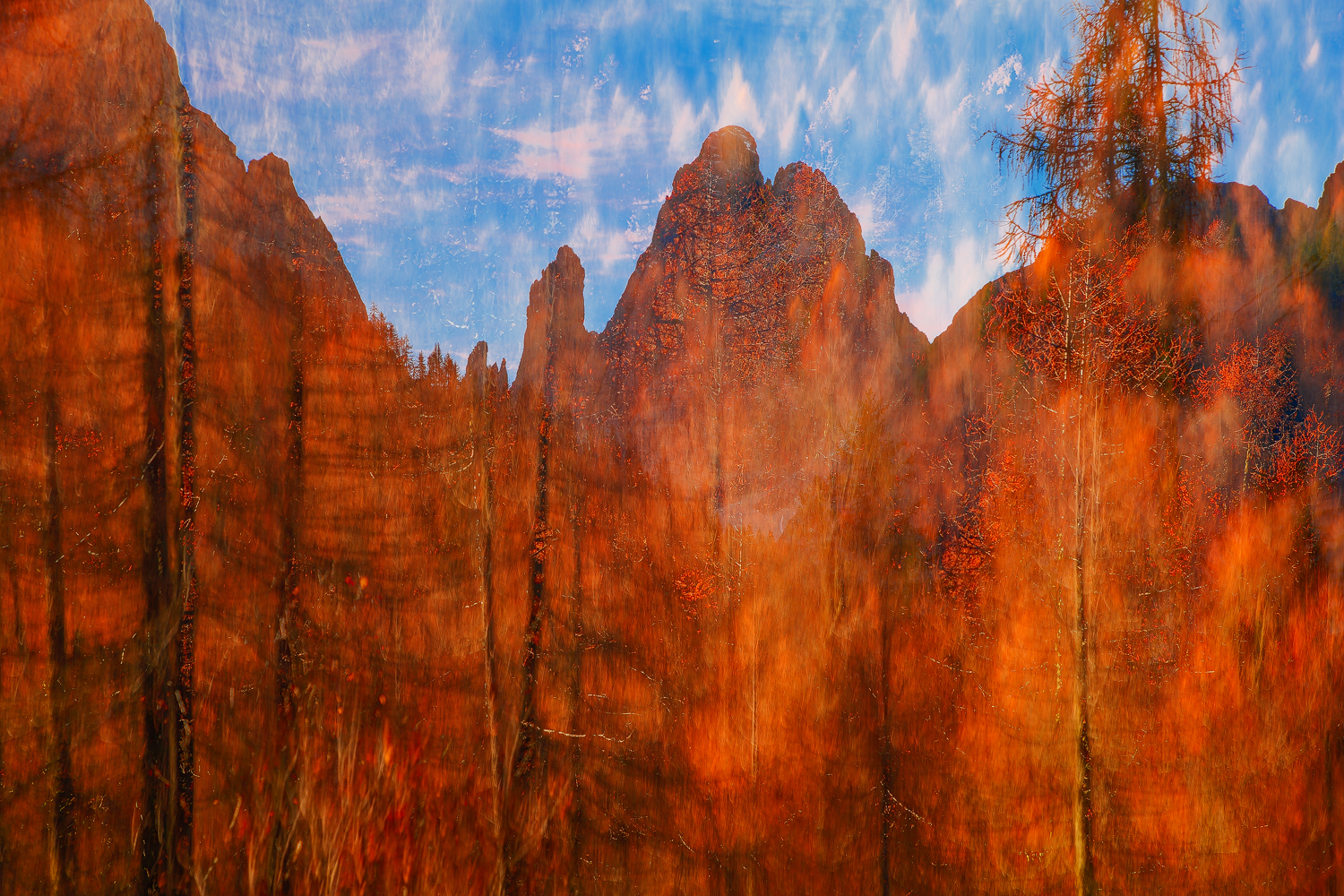 Blazing larch forest with dramatic Dolomite peaks under a vibrant sky