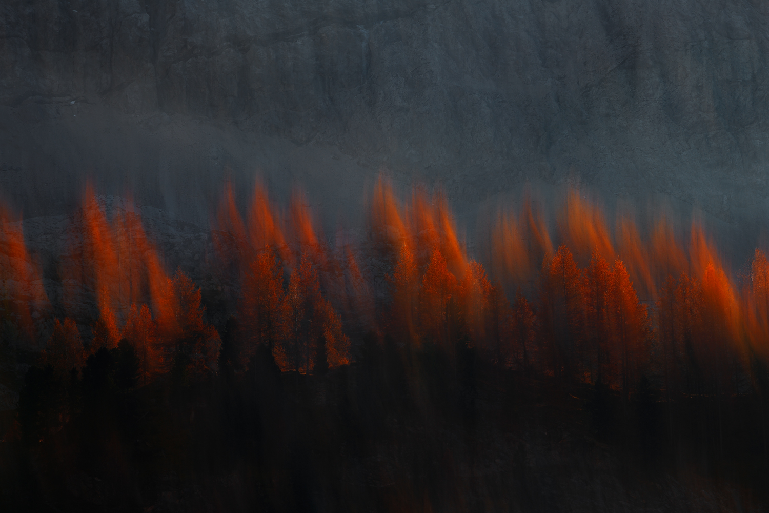 Fiery peaks pierce the misty twilight in the Dolomites